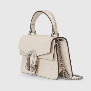 A white DIONYSUS MINI TOP HANDLE BAG with a chain and studs.