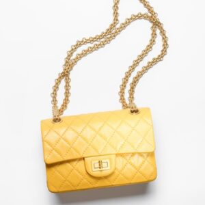 A yellow MINI 2.55 HANDBAG on a white background.