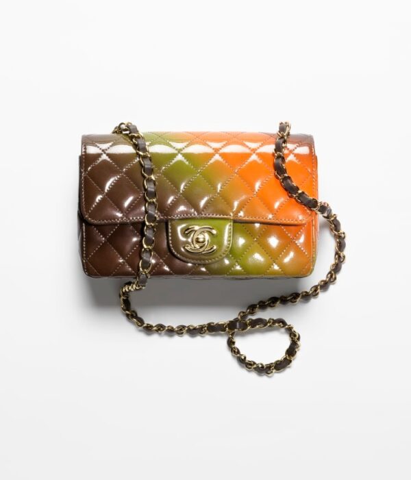 A MINI FLAP BAG with a colorful pattern on it.