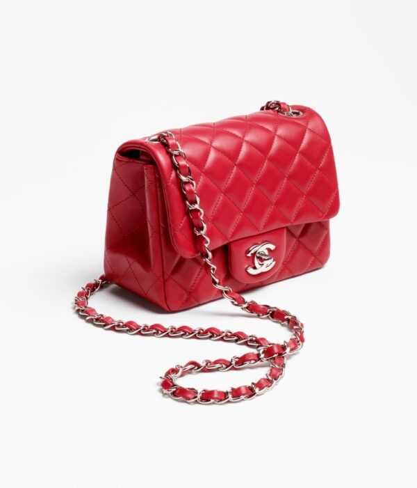 Chanel's red Mini Flap Bag in white background.