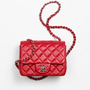 Chanel's red Mini Flap Bag in white background.