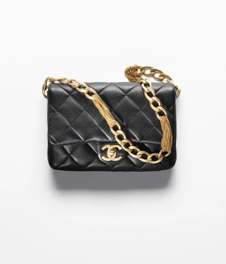 Chanel small black flap bag with gold chain.