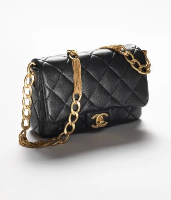 Chanel small black flap bag with gold chain.