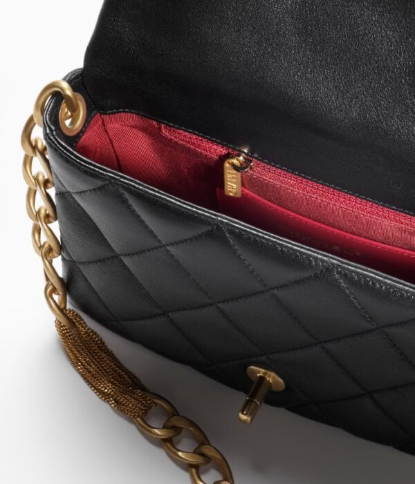 Chanel small black flap bag with gold chain.